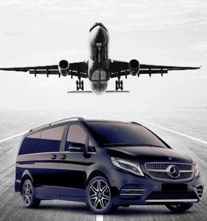 a van is parked on a runway with an airplane