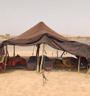 a tent on the beach in the desert