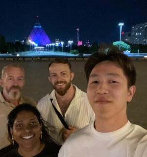 a group of people posing for a picture at night