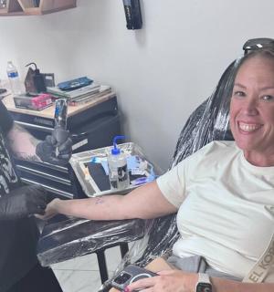 a woman sitting in a chair in front of a dentist
