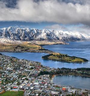 an aerial view of a city in front of a mountain