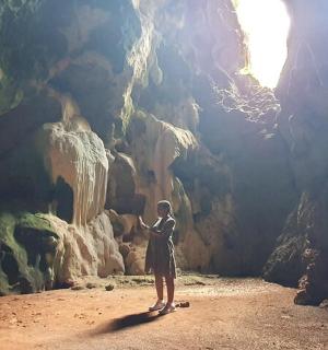 a person standing in front of a cave