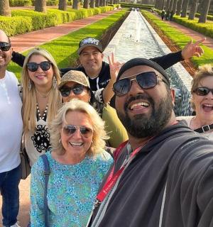 a group of people posing for a picture in front of a fountain