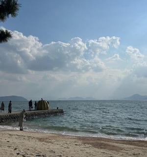 a group of people walking on a pier near the water