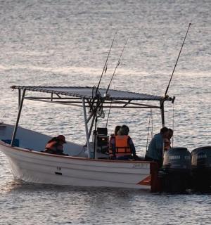 a group of people on a boat in the water