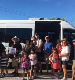 a group of people standing in front of a van