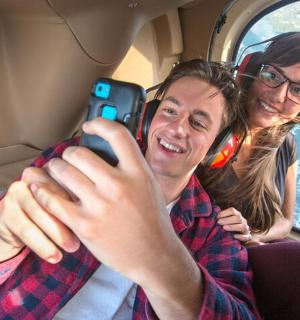 a man and a woman taking a picture in a car