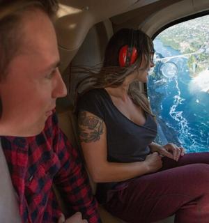 a man and a woman sitting in the back seat of an airplane