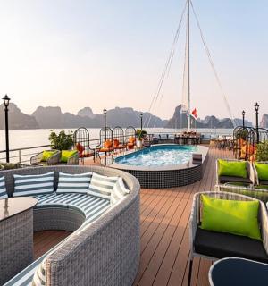 a deck of a boat with a pool and chairs