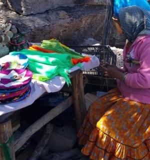 eine Frau sitzt neben einem Tisch mit einem Korb