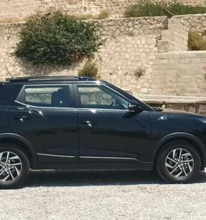 a black suv parked in a parking lot