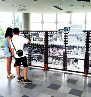 a man and a woman looking at a display in a museum