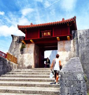 a man walking up some stairs in front of a building