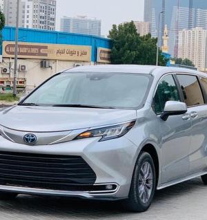 a white toyota hybrid car parked on a city street