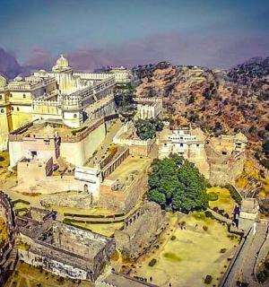 an aerial view of a large building on a mountain