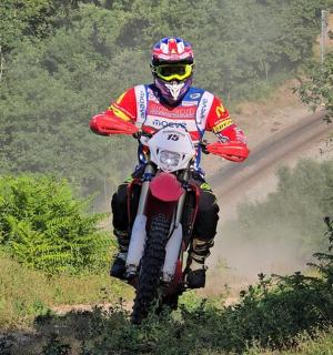 a person riding a dirt bike on a dirt road