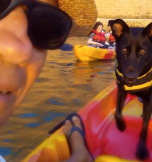 a man and a dog on a raft in the water