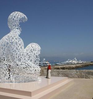 a man standing in front of a sculpture
