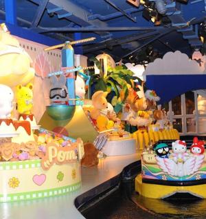 a table with a cake and stuffed animals on it