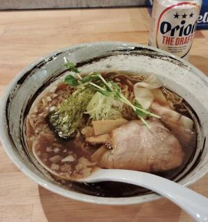 a bowl of soup with meat and vegetables on a table