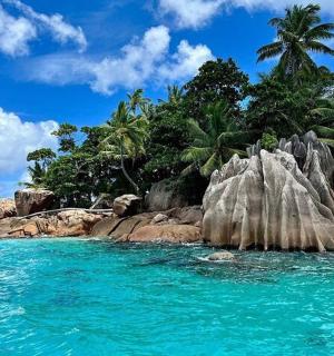 a tropical island with rocks in the water