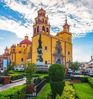 城市中一座带有钟楼的黄色建筑