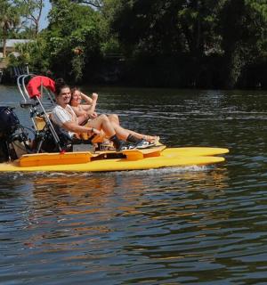 two people sitting on a boat on the water