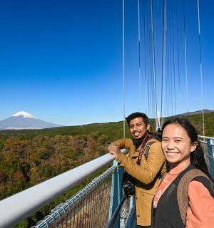 two people standing on a viewing deck of a mountain