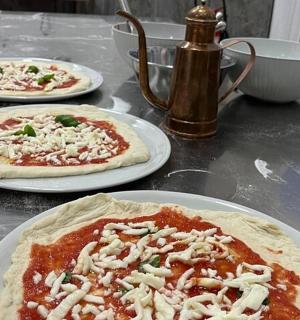 three pizzas sitting on plates on a table