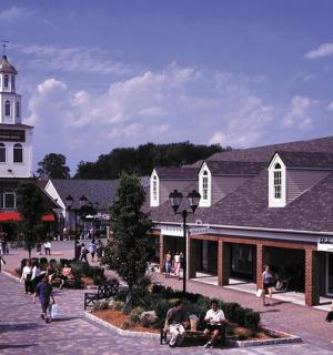 a group of people walking in front of a building