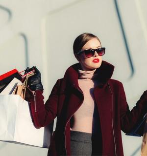 a woman holding shopping bags in her hands