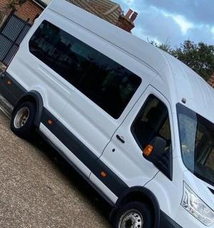 a white van parked next to a brick building