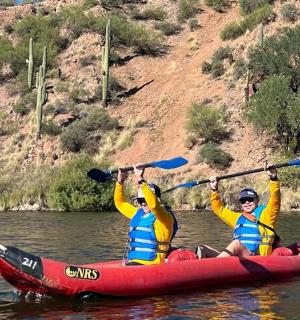 two people in a red kayak on the water