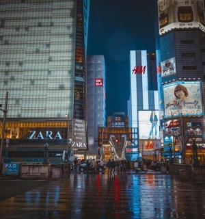 a busy city street at night with tall buildings