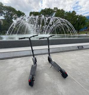 a scooter parked in front of a fountain