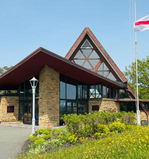 a flag flying in front of a building