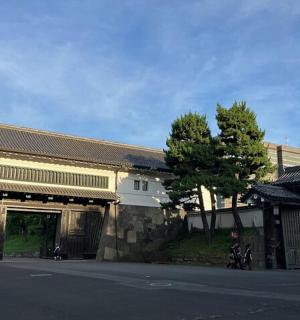 a building with a gate in the middle of a street