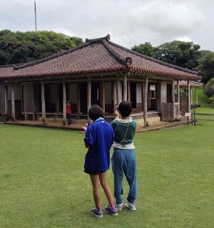 two people standing in front of a building