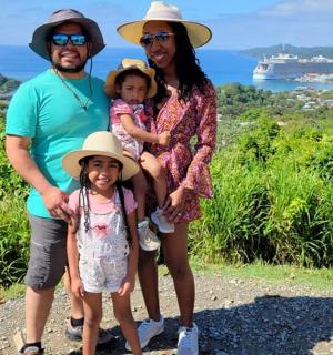 a family posing for a picture on top of a hill