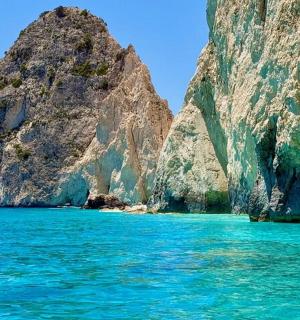 a view of the water near a rocky mountain