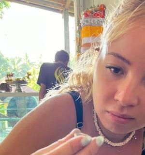 a young girl is looking at her cell phone