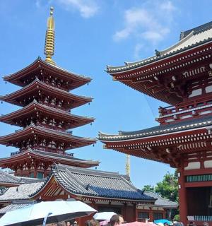two tall buildings with people standing in front of them