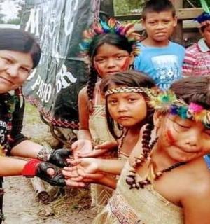 a group of children standing next to a woman