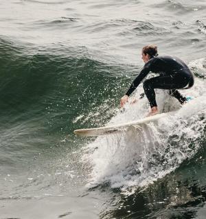 a man riding a wave on a surfboard in the ocean