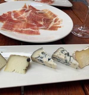 two plates of cheese and bacon on a table