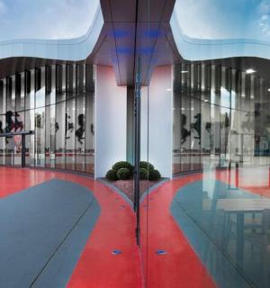 a building with glass walls and a red floor