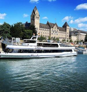 a large boat in the water in front of a building