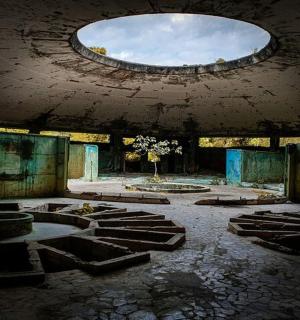 an abandoned building with a round window in the ceiling