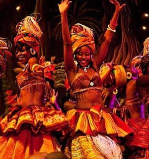 a group of women in costumes on a stage