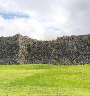 a large stone building on top of a grass field
